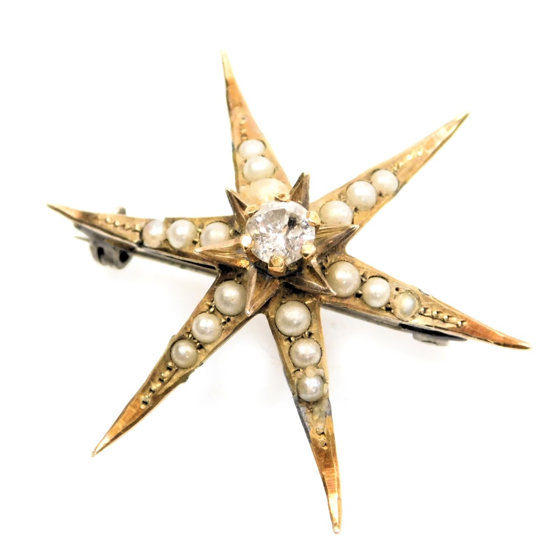 A Victorian 9ct gold diamond and seed pearl star brooch, of six pointed form, 3.4g.