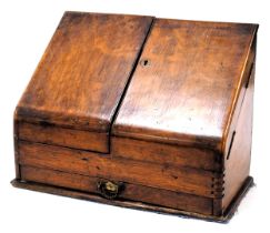 A Victorian oak stationary rack, with a partially fitted interior, 29cm high, 38cm wide, 18.5cm deep