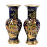 A pair of early 20thC Carlton ware lustre vases, of baluster form, decorated with a pagoda in a land