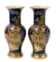 A pair of early 20thC Carlton ware lustre vases, of baluster form, decorated with a pagoda in a land