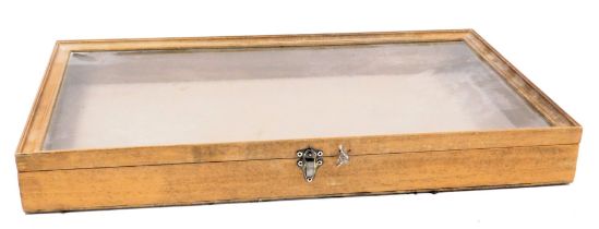 A light oak bijouterie cabinet, with a perspex set, hinged lid, width 61cm, depth 35.5cm.