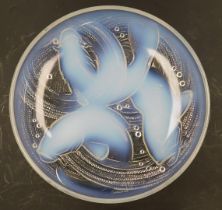 An early 20thC French opalescent glass dish, by Pierre d'Avesn, decorated with three swimming carp,