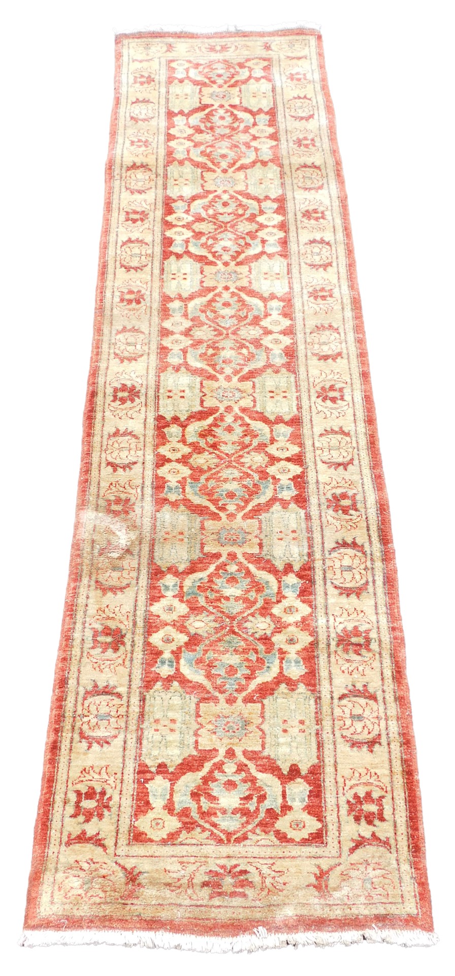 An Afghan red ground runner, decorated with repeating floral medallions and motifs, within repeating