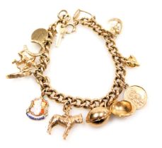 A 9ct gold curb link charm bracelet, with thirteen charms as fitted, on a bolt ring clasp, 34.7g.