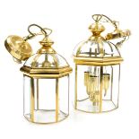 A pair of graduated hexagonal brass framed hall lanterns, with bevelled glass plates, the larger wit