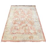 A Ziegler red and cream ground rug, decorated with floral and foliate motifs, within repeating flora