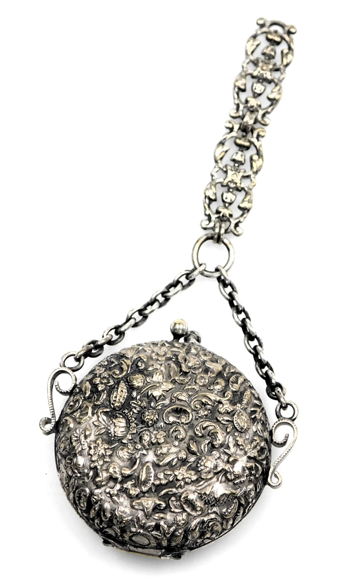 A Victorian pendant purse, possibly from a chatelaine, of white metal, circular form, embossed with