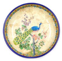 An early 20thC Longwy pottery bowl, of footed form, enamel decorated with a peacock on an apple blos