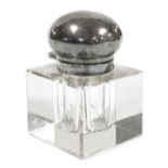 An early 20thC cut glass inkwell, of cube form, with a silver mount and hinged lid, bears indistinct