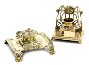 A Victorian brass inkwell with embossed floral and foliate decoration, with a ceramic insert, 13cm w