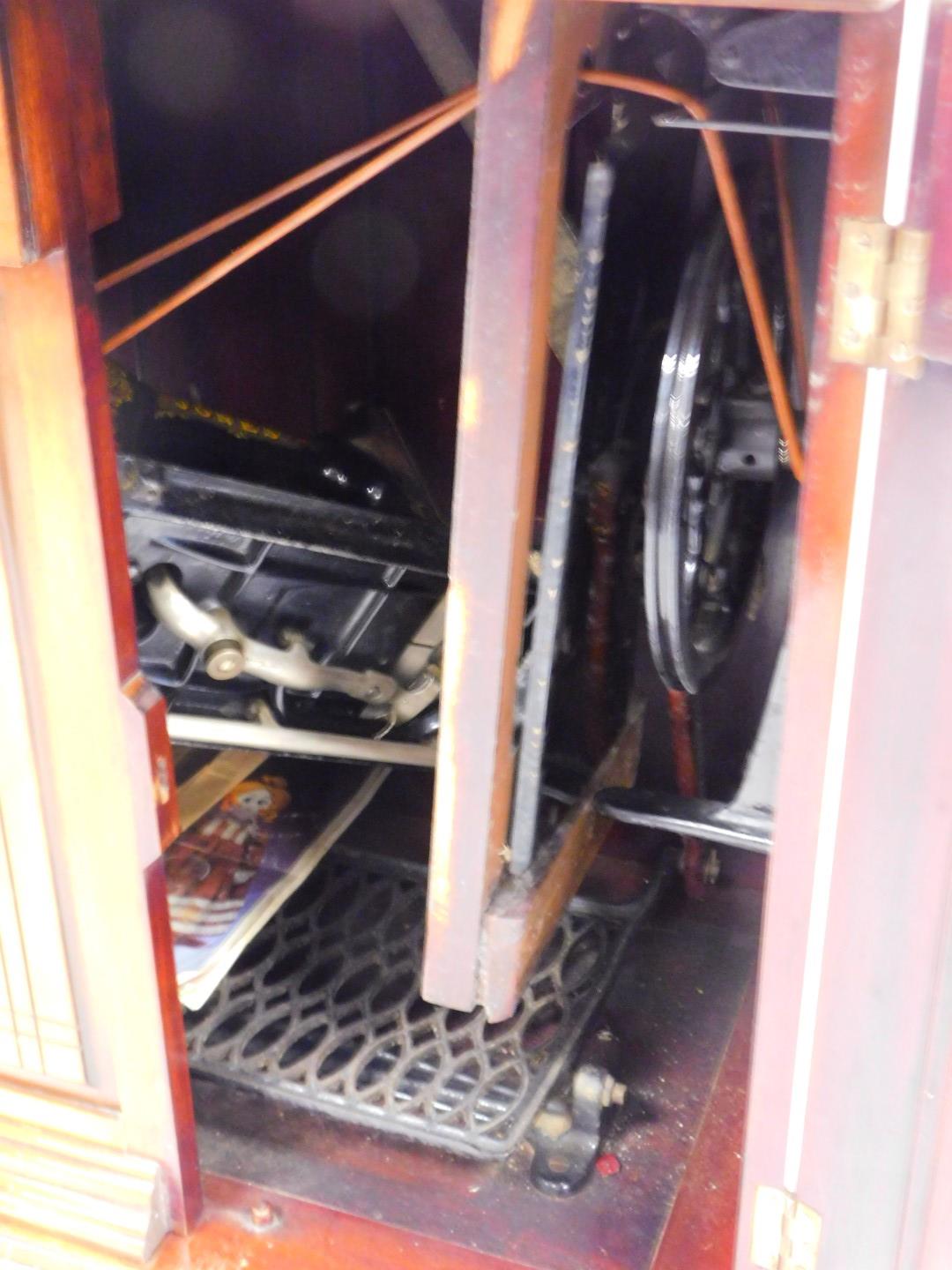 A Victorian mahogany sewing cabinet, containing a Jones Family C.S treadle sewing machine, 77cm high - Image 2 of 2