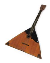 A late 20thC Soviet wooden cased balalaika, impressed CCCP mark, 66cm high.