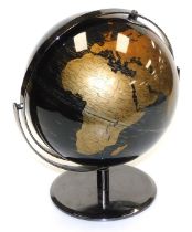 A black and gold terrestrial globe, on a mirrored base, 33cm high.