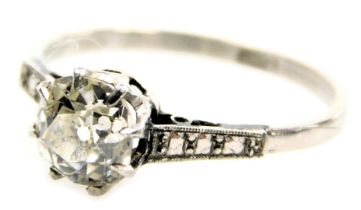 A platinum and diamond solitaire ring, the brilliant cut diamond in a claw setting, with diamond set