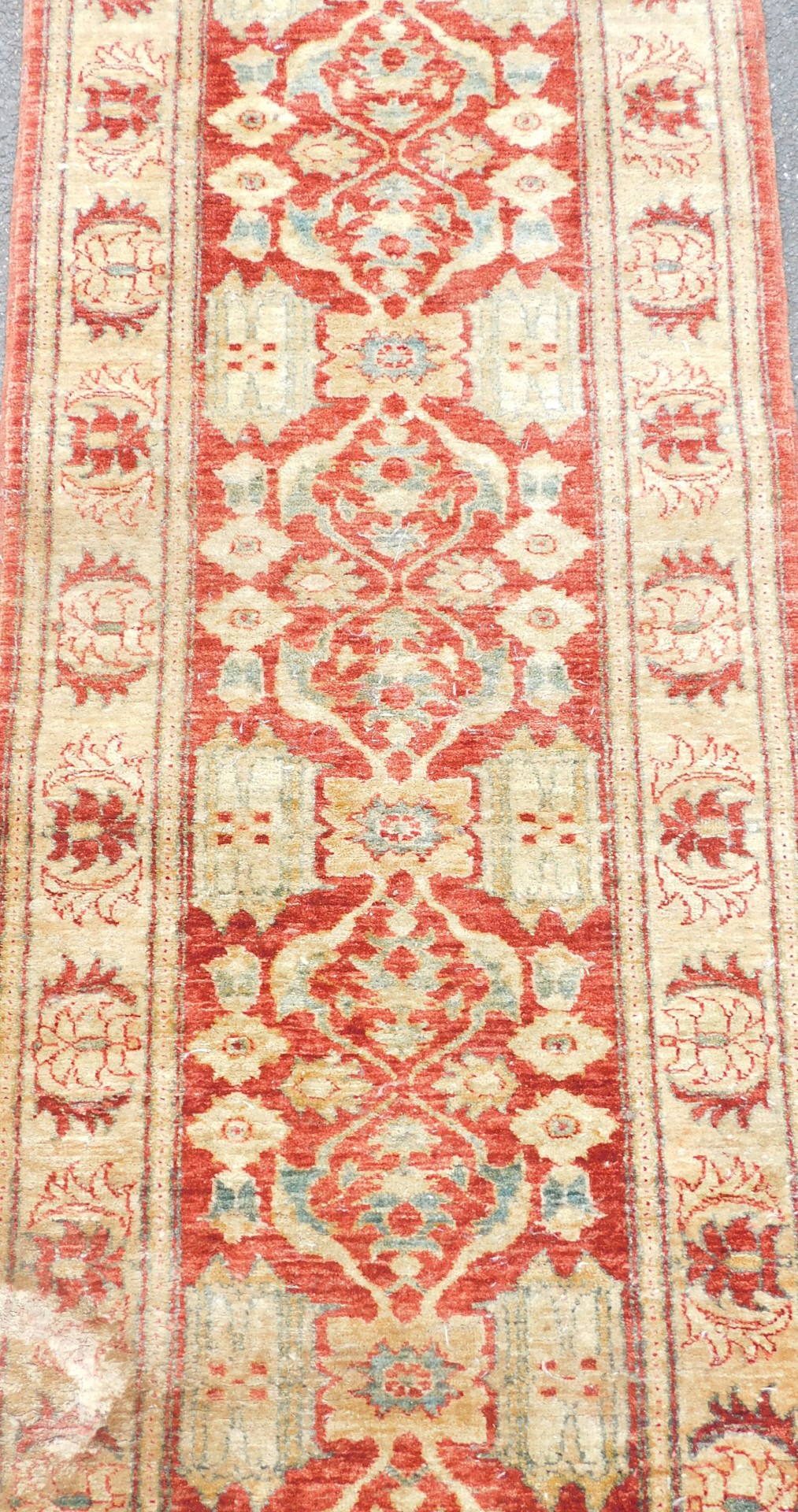 An Afghan red ground runner, decorated with repeating floral medallions and motifs, within repeating - Image 2 of 3