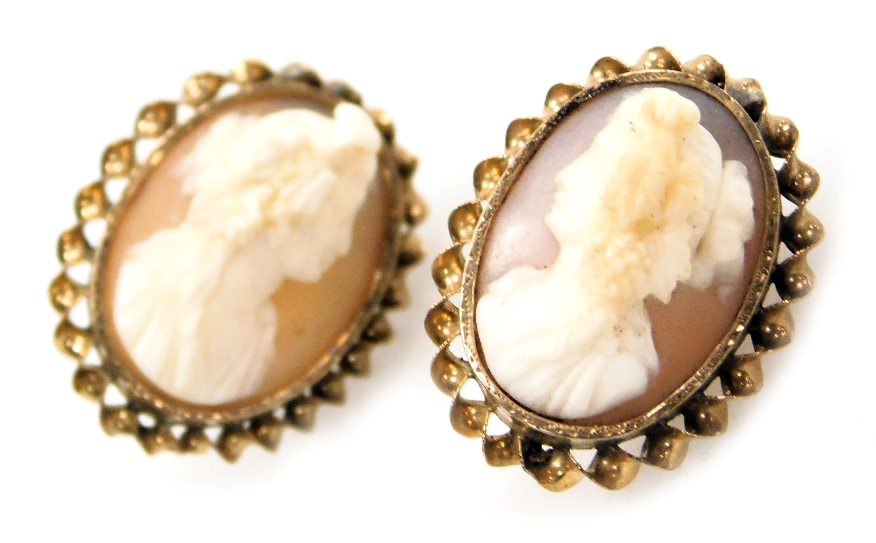 A pair of Victorian cameo earrings, bust portraits of ladies, facing left and right, in a yellow met