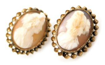 A pair of Victorian cameo earrings, bust portraits of ladies, facing left and right, in a yellow met