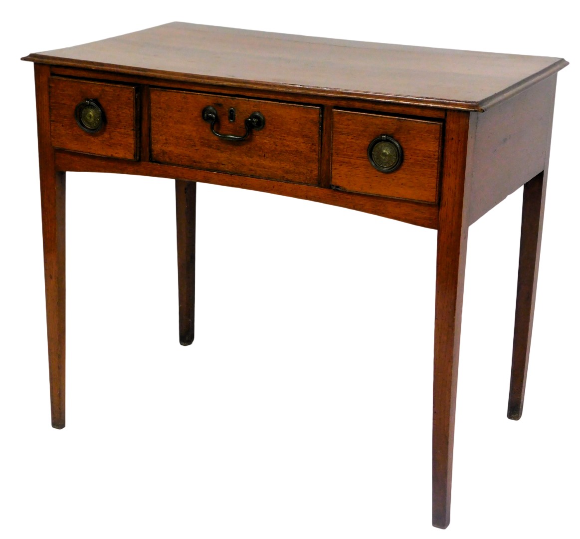 A George III oak side table, with one long flanked by two short drawers, raised on tapering square l