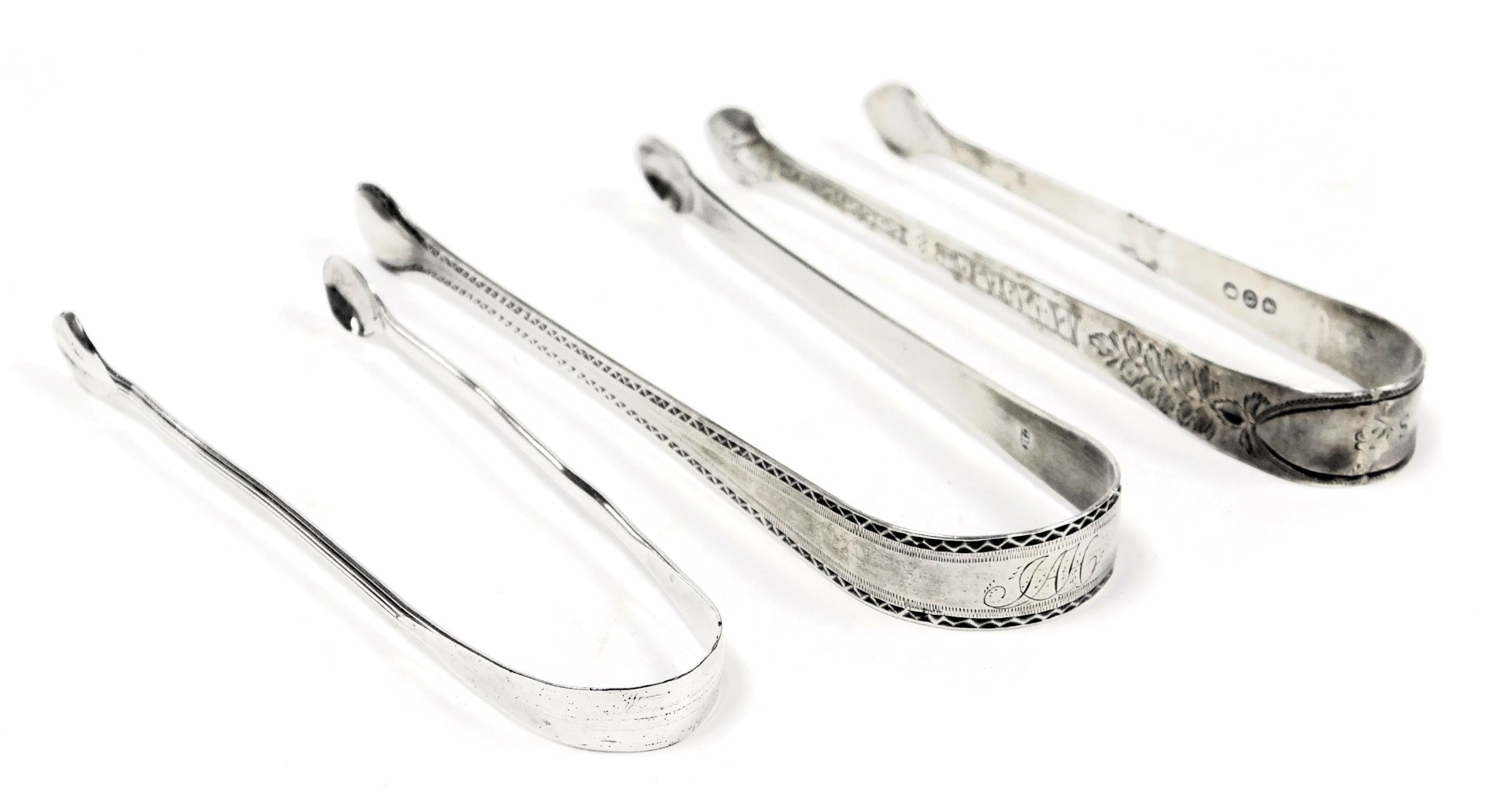 Three George III silver sugar tongs, with engraved decoration, 2.22oz.