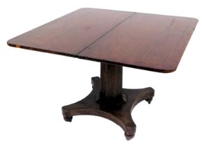 A late Georgian mahogany fold over tea table, with ebony line inlay, raised on an octagonal column a