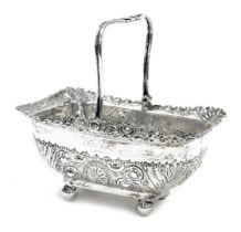 A Victorian silver sugar basket, with embossed and engraved foliate decoration, raised on four ball