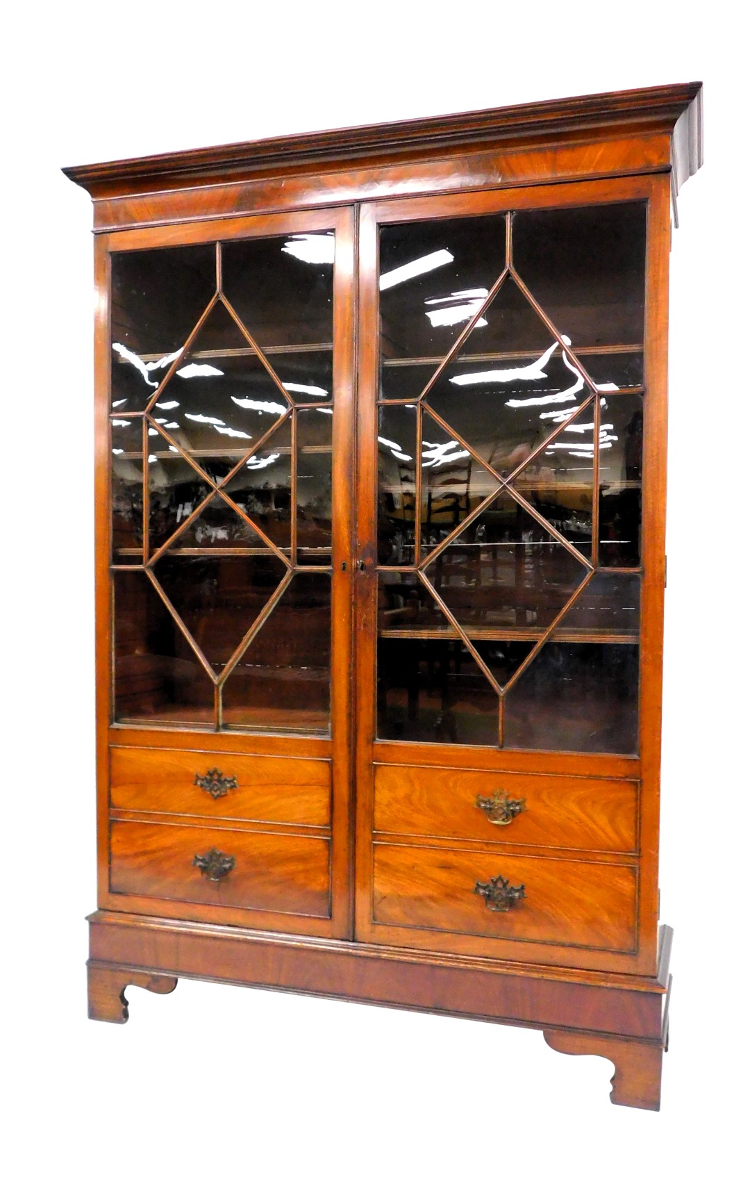 A George III mahogany display cabinet, the outswept pediment over a pair of astragal glazed doors, w