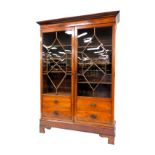 A George III mahogany display cabinet, the outswept pediment over a pair of astragal glazed doors, w