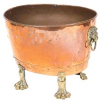 A Victorian copper and brass planter, of oval form, with twin lion's head and ring handles, raised o