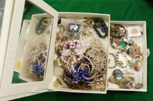 A two tier jewellery box, containing necklaces, bangles, ring, etc.