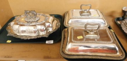 A pair of silver plated tureens and covers, together with another, bearing crests.