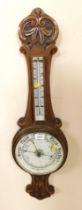 A Victorian oak wheel aneroid barometer, with thermometer, leaf carved, 82.5cm high.