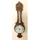 A Victorian oak wheel aneroid barometer, with thermometer, leaf carved, 82.5cm high.
