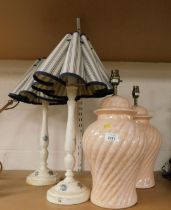 Four lamps, two of pink ovoid form, and two wooden, with shades decorated with flowers.