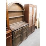 A 20thC oak Welsh type dresser, the arched top above three shelves, the base with two drawers above