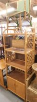 A group of furniture, to include a wicker armchair, magazine rack, caned and wicker open shelves wit