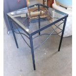 A glass topped occasional table.