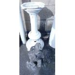 A white painted cast metal plinth or birdbath, 73cm high, together with a concrete garden ornament m