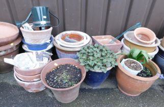 A group of terracotta garden pots, blue glazed examples, green metal watering can, etc. (a quantity)