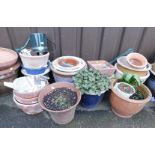 A group of terracotta garden pots, blue glazed examples, green metal watering can, etc. (a quantity)