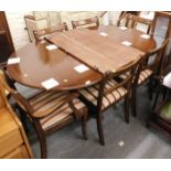 A 20thC mahogany and inlaid extending dining table, together with six Regency style chairs with drop