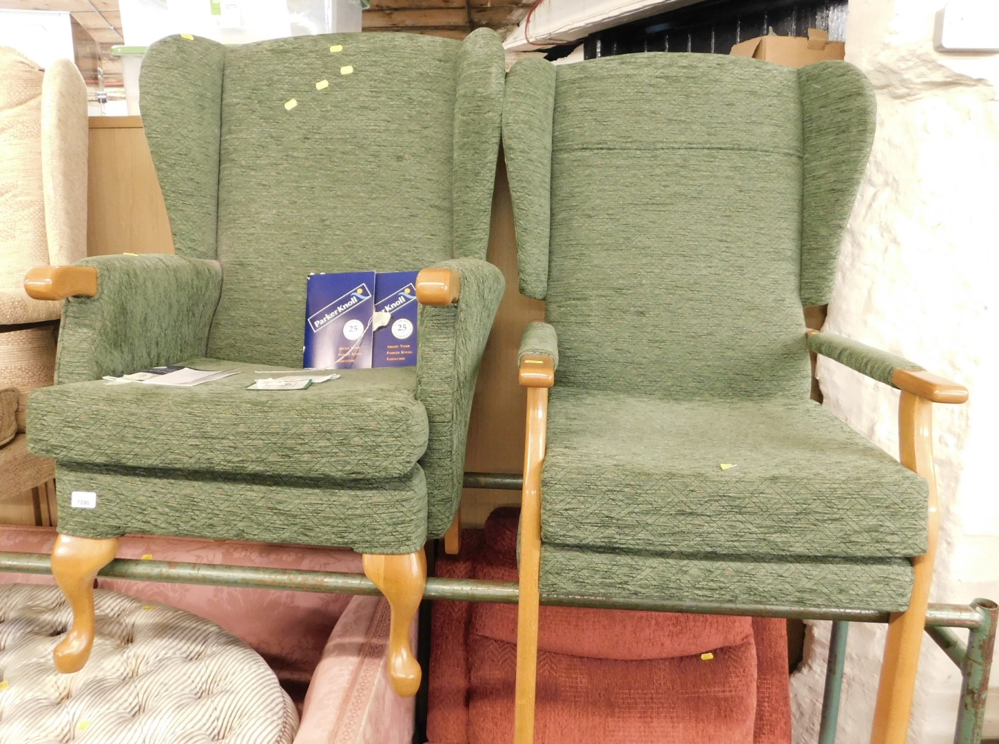 A pair of Parker Knoll lady's and gentleman's oak framed armchairs, in green upholstery. (2) The uph