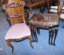 A mahogany nest of three tables, each inset with a glass top, the largest 56cm high, together with a