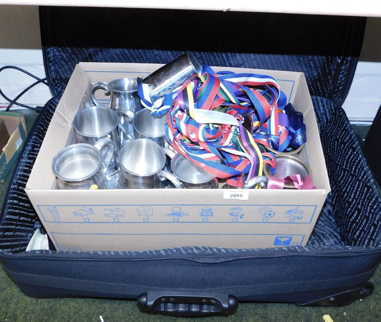 A Dunlop suitcase containing various tankards, Rowing Club medals, etc. (a quantity)
