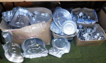 A large quantity of cake tins, mostly pictorial designs, including Batman, balloon, guitar, etc., to