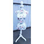 A clothes mannequin, upholstered in pink rose fabric, 135cm high.