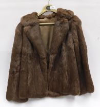 A lady's size 10 three quarter length fur coat.