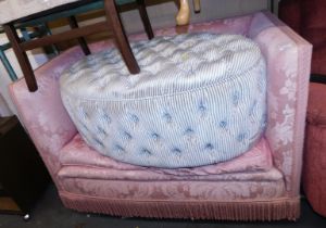 A mid century two seater sofa, upholstered in pink foliate fabric, together with an oval footstool w