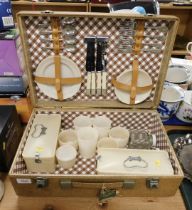 A picnic hamper, in case, fitted with plates, cups, saucers, boxes, knives, forks and spoons, the ca