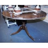 A 20thC mahogany and cross banded dining table, the circular top above a turned column, on sabre leg