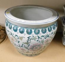 An Oriental style pottery jardiniere, decorated with pink flowers, green leaves against a white grou